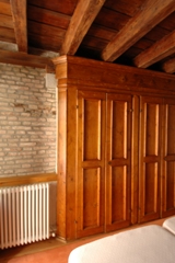 Room with a wide ancient built-in wardrobe